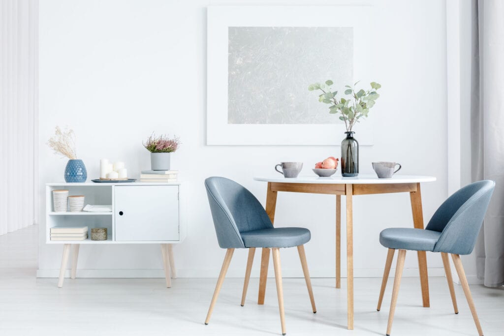 Small dining room with light colors and blue for contrast