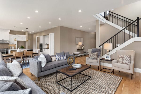 Beautiful living room interior with hardwood floors and and view of kitchen in new luxury home