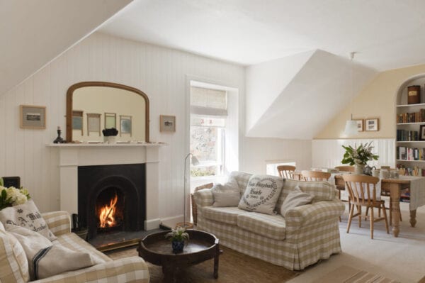 Open-plan sitting room and diner with white and beige gingam sofas (Ektorp from Ikea)