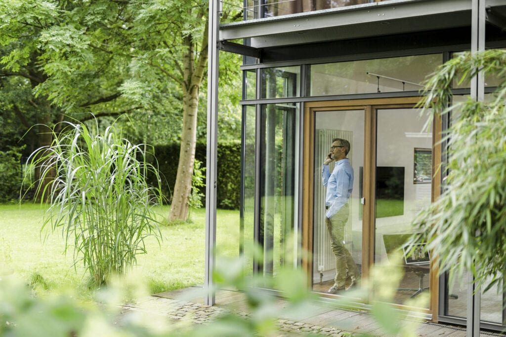 A grey haired man at home in his design house, germany