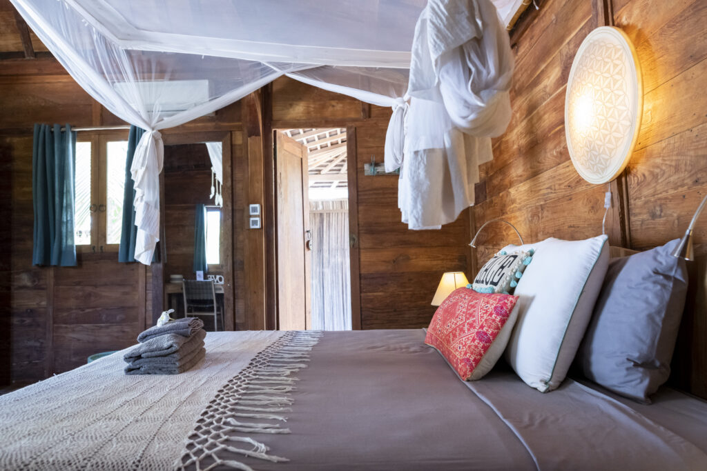 Side view of luxury island resort bed with mosquito net