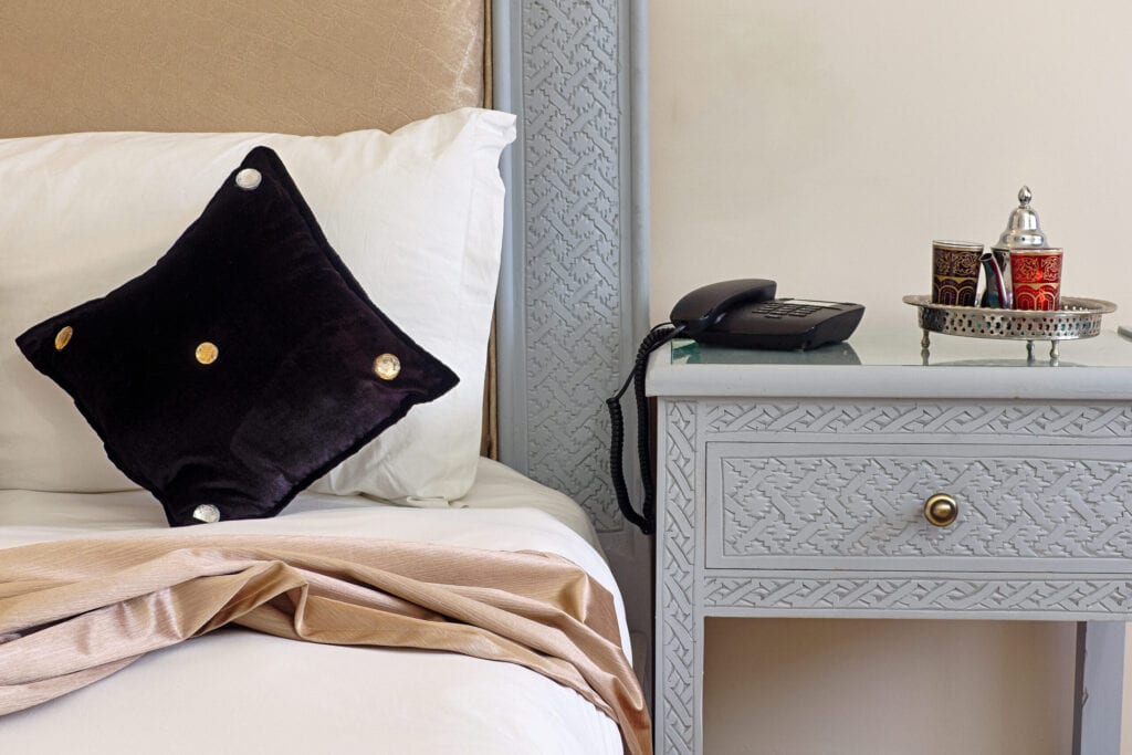  Tea service on a nightstand in an hotel bedroom in moroccan style