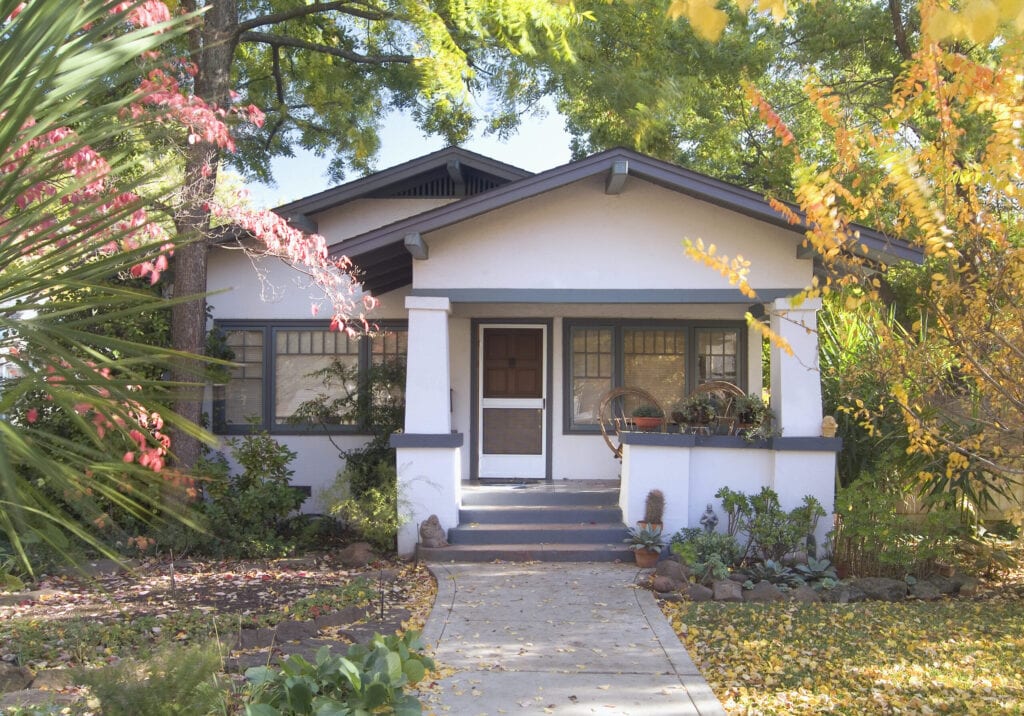 Front exterior white bungalow with blue trim