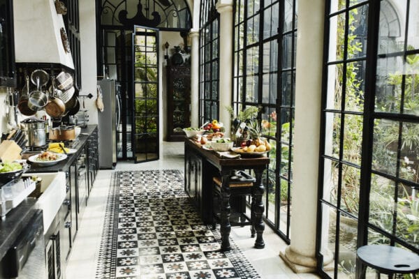 View of kitchen with sideboard filled with food for dinner party