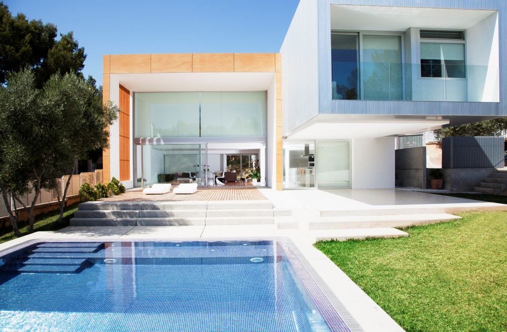 Lap pool in backyard of modern mansion