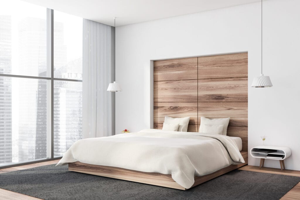 Modern bedroom with wooden headboard built into the wall