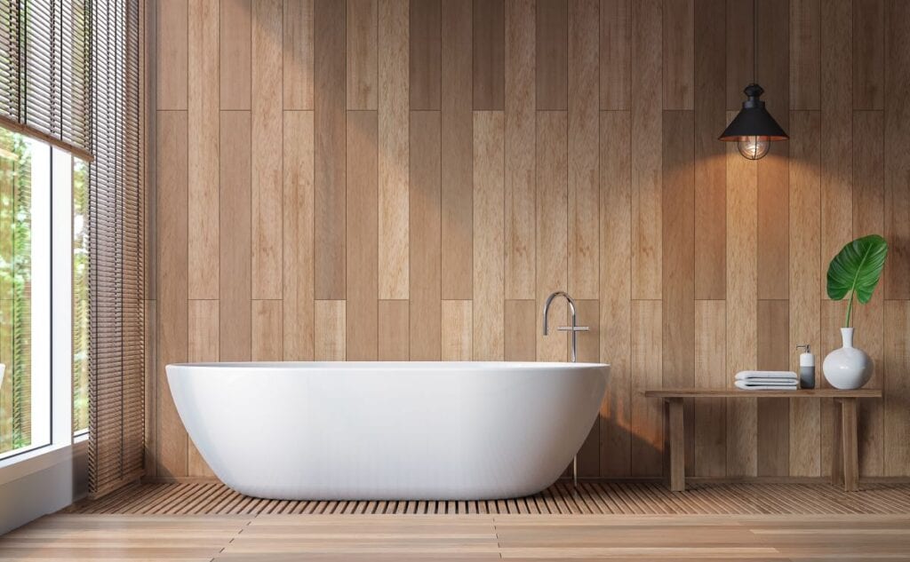 Modern bathroom with wood walls and floors and pristine white bathtub
