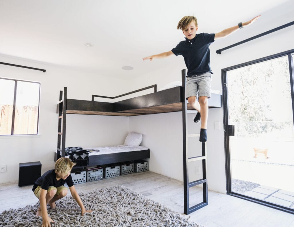 boys jumping off of bunkbeds
