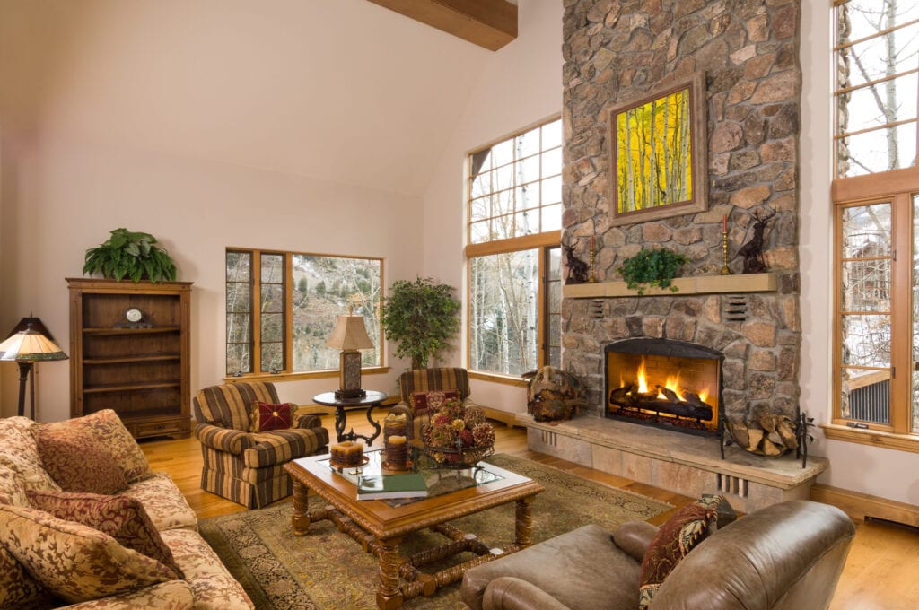 Beautiful interior of mountain home nestled in aspen trees.  Photo above fireplace is photographer's own image - iStock image #23312103.   Captured as a 14-bit Raw file. Edited in 16-bit ProPhoto RGB color space.