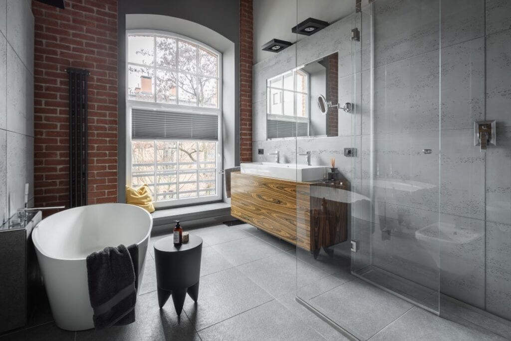 Industrial style bathroom with exposed brick wall