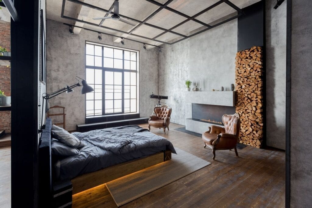 Luxurious industrial style bedroom with fireplace and large windows