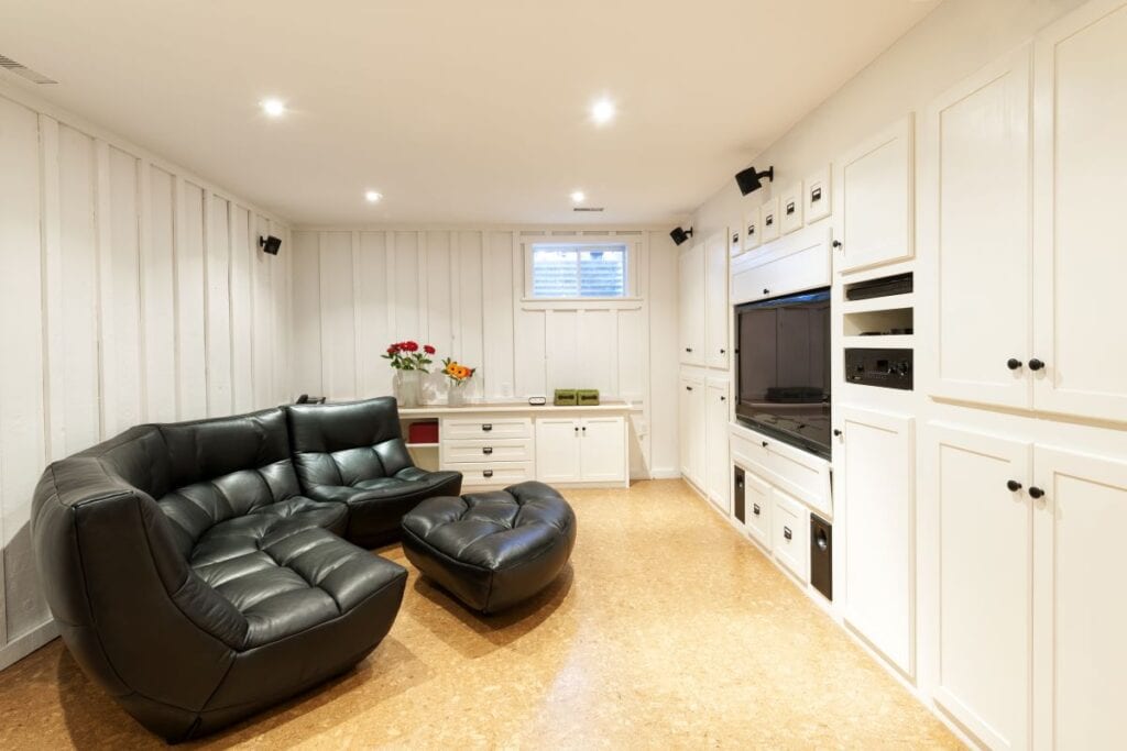 Finished basement with cork flooring and white painted walls