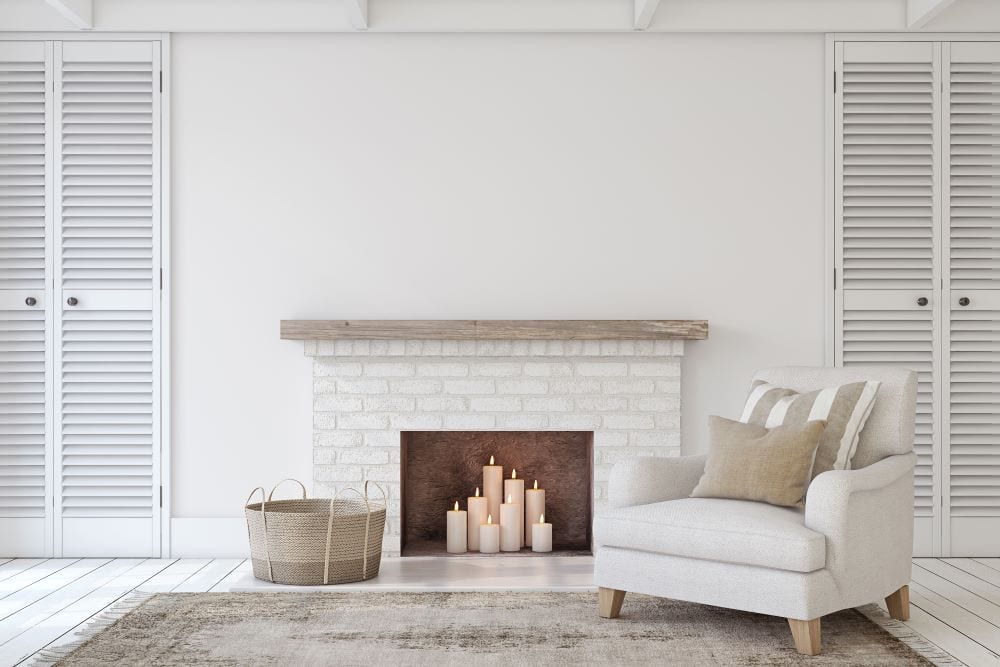 Candles in fireplace, white living room