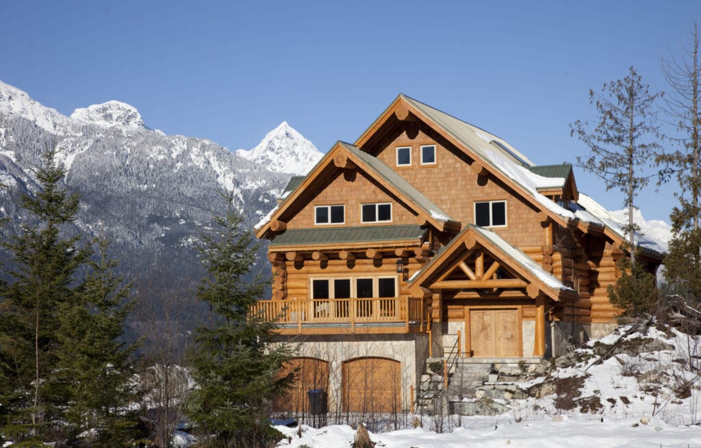 A house typical of west coast architechture, sits against the backdrop of the Tantalus Range in Squamish, British Columbia.