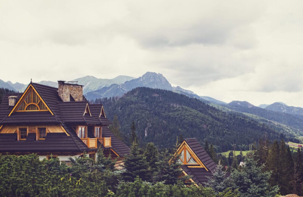  Poland - August 17, 2014: Mountain scene with wooden idyllic country estates with wood shingle roof in Zakopane, Poland.