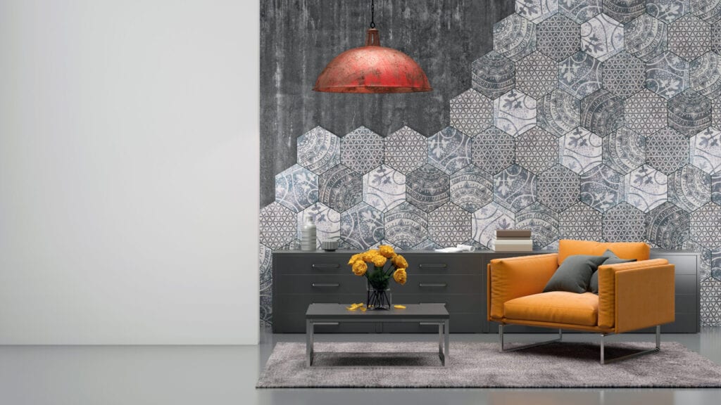 Living room interior with vibrant orange armchair, carpet, coffee table with flowers, hexagonal tiles on the wall, pendant light above, decorative ornate design. blank white wall for copy space artist template