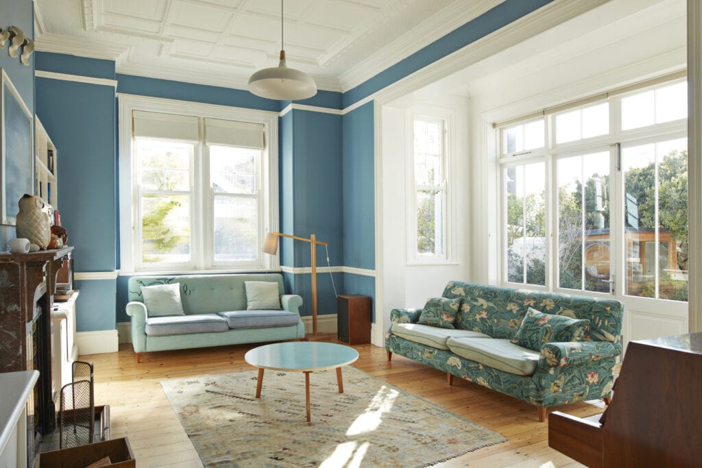 Living room with blue couches and walls