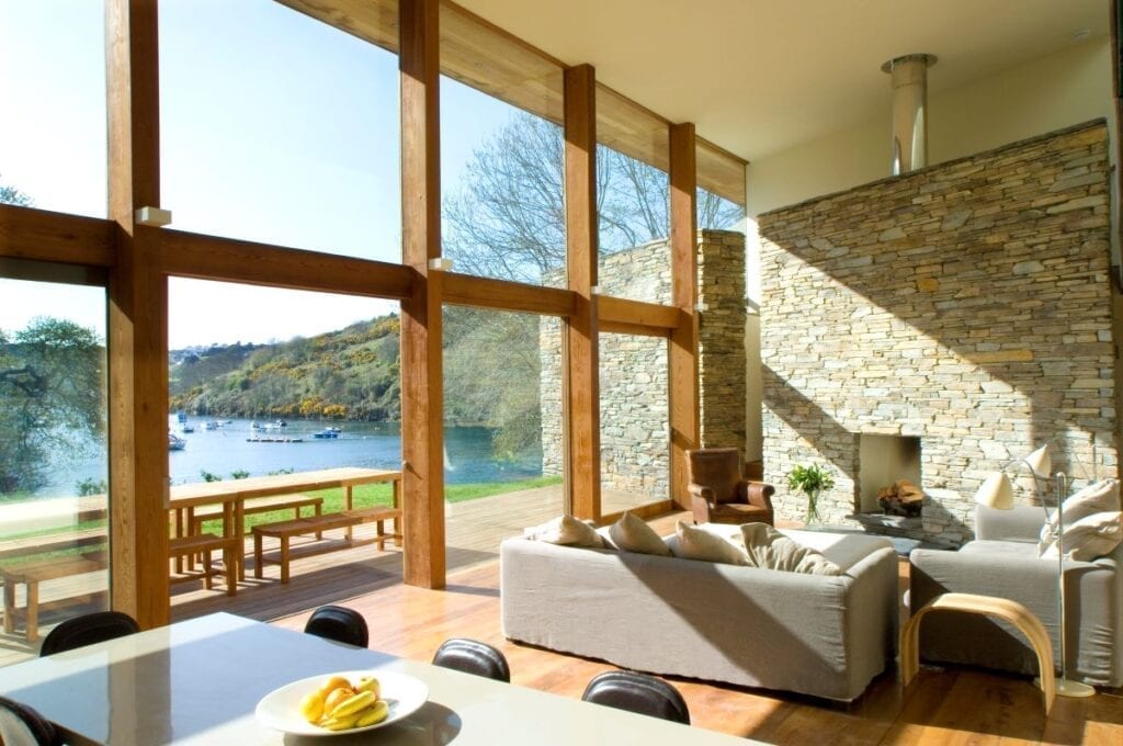Large windows with panoramic view of lake in living room