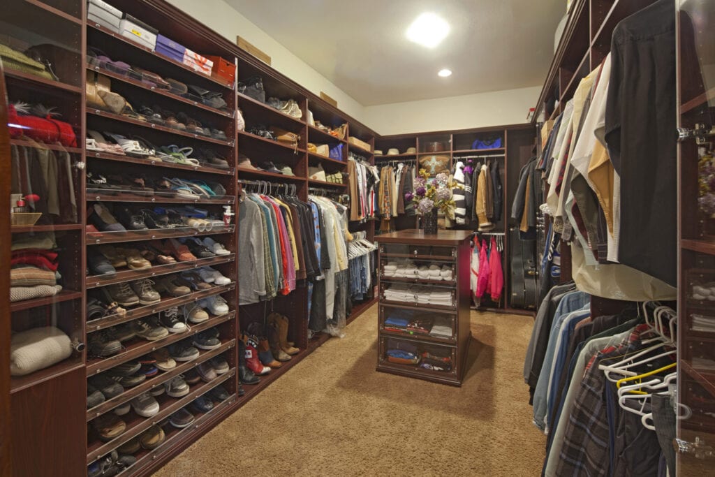 Walk in closet with organized clothing