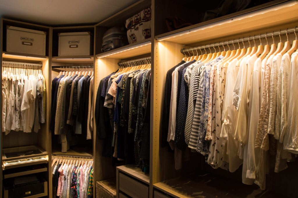 Luxurious walk in closet with lighting and jewelry display.