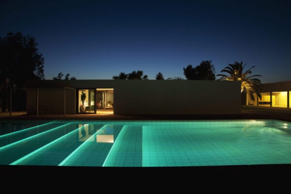 Pool outside modern house at twilight