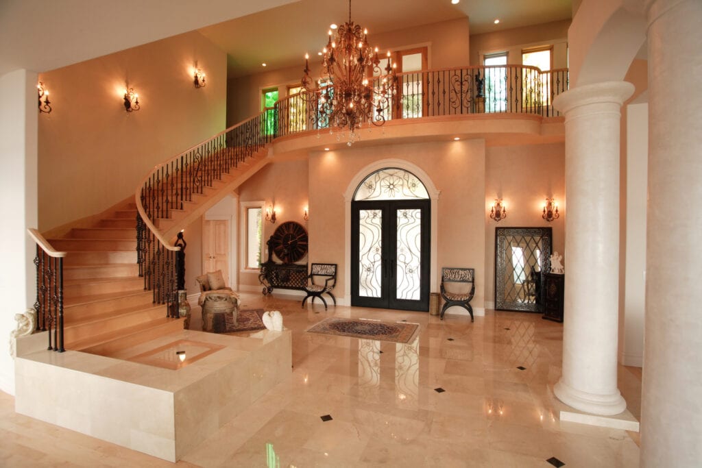 Luxury home interior with marble columns and large staircase