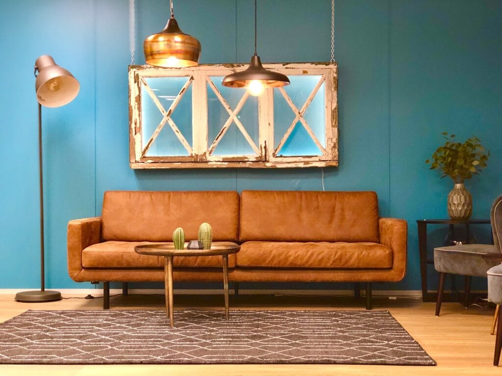 Blue painted living room with brown couch