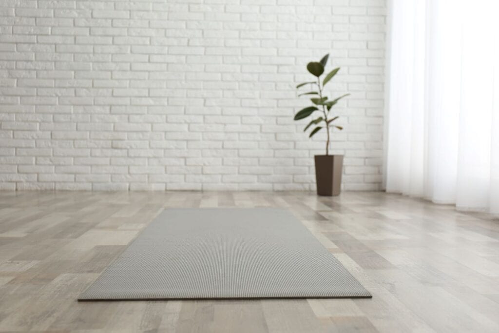 Crisp white yoga room with yoga mat and no clutter