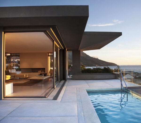 Modern living room and patio next to swimming pool