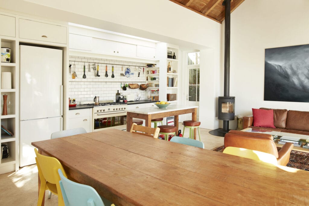 Wooden dining table arranged against kitchen counter at home