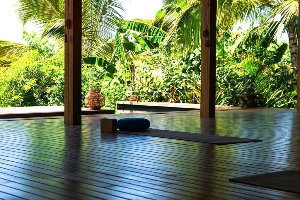 Tropical outdoor meditation room with yoga mats