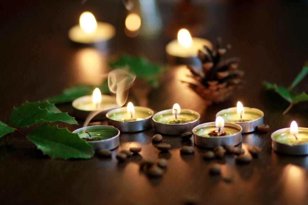 Scented candles with pinecones and coffee beans