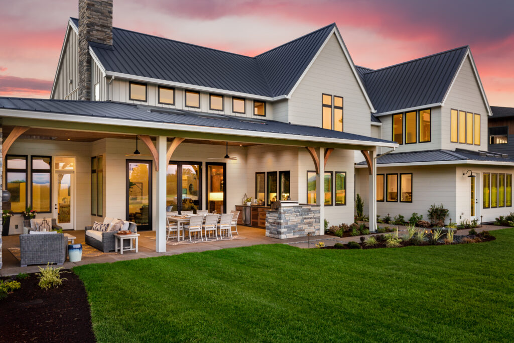 facade of home with manicured lawn and large covered patio