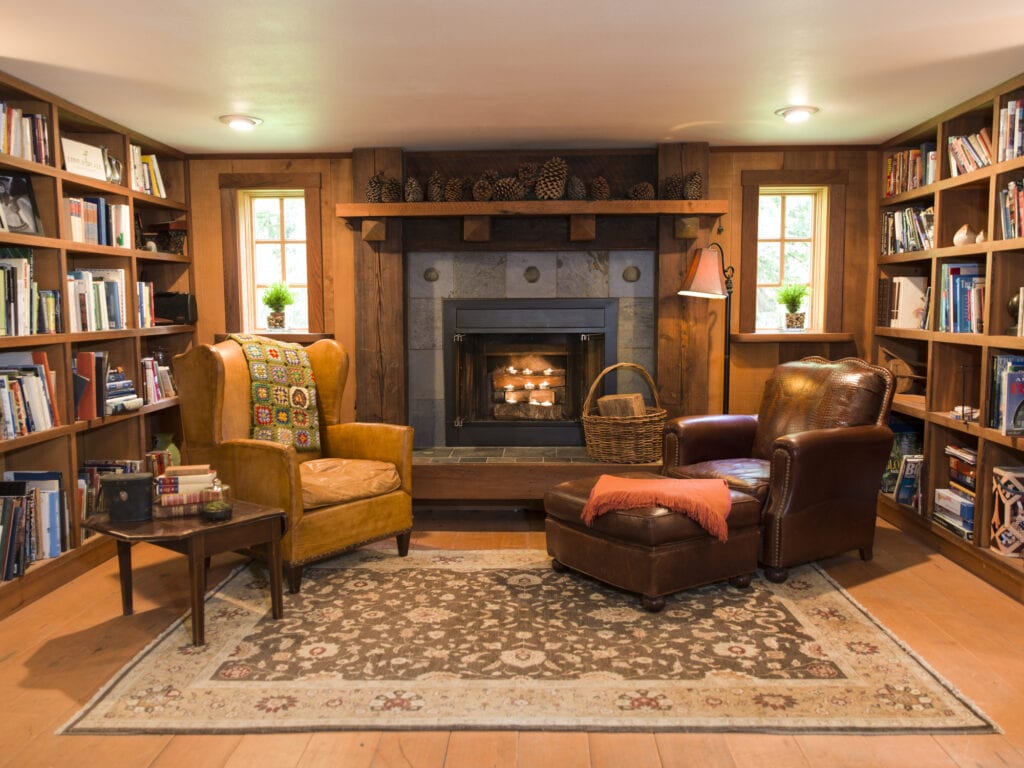 big fireplace and two leather chairs
