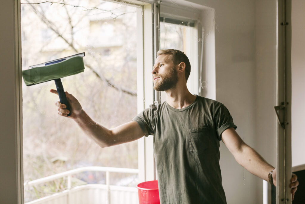 man cleaning window