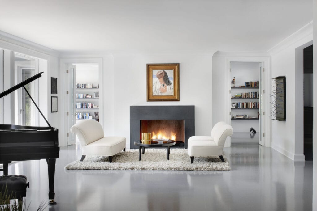 Modern family room with glowing fireplace and grand piano in this Chicago IL residence.