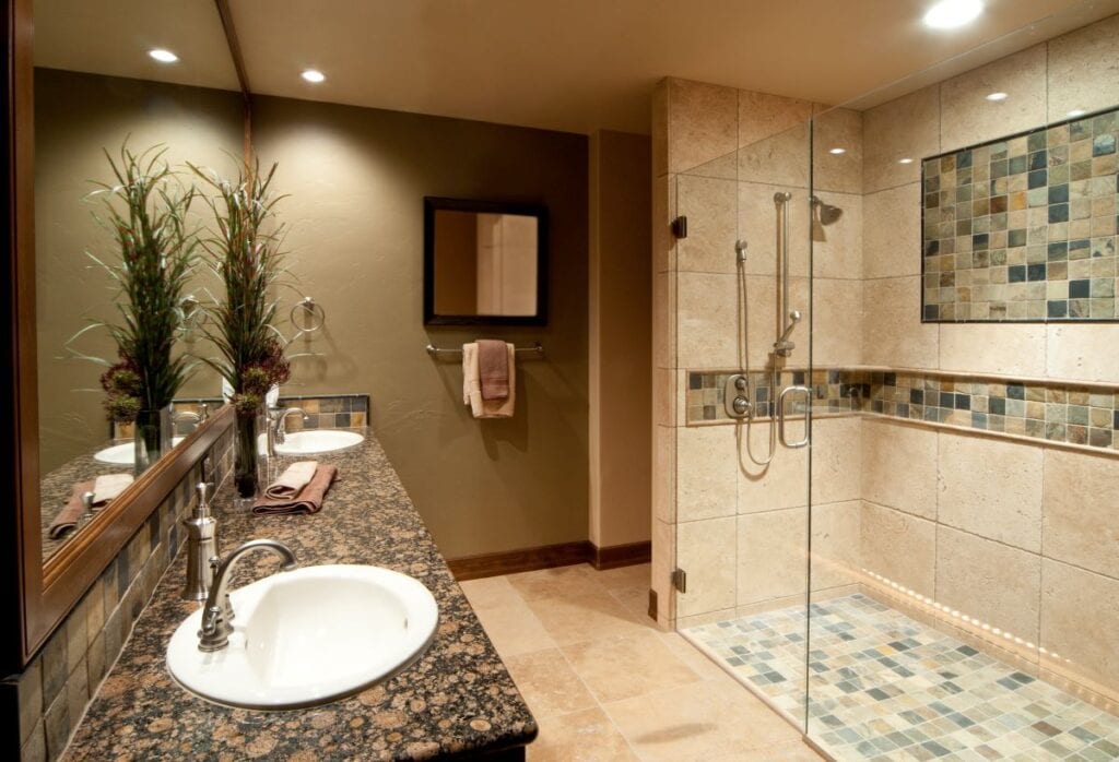 Mediterranean style bathroom with tile shower and border tile