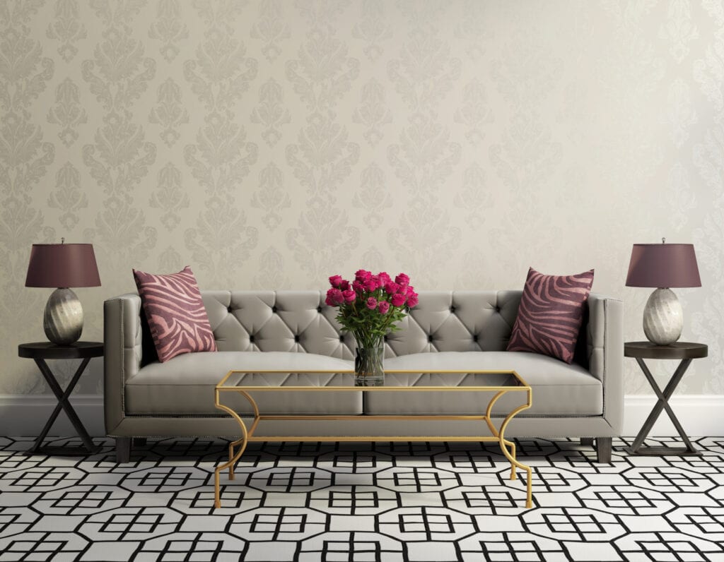 Vintage classic elegant living room with grey velvet sofa, side tables and a vase with pink flowers
