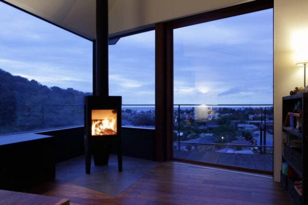 Modern living room with fireplace at dusk