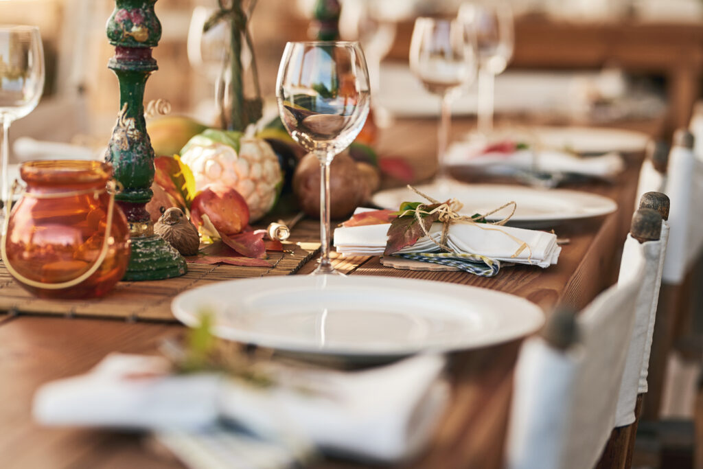 Shot of a nicely set diner table with different kinds of plates and glasses on it