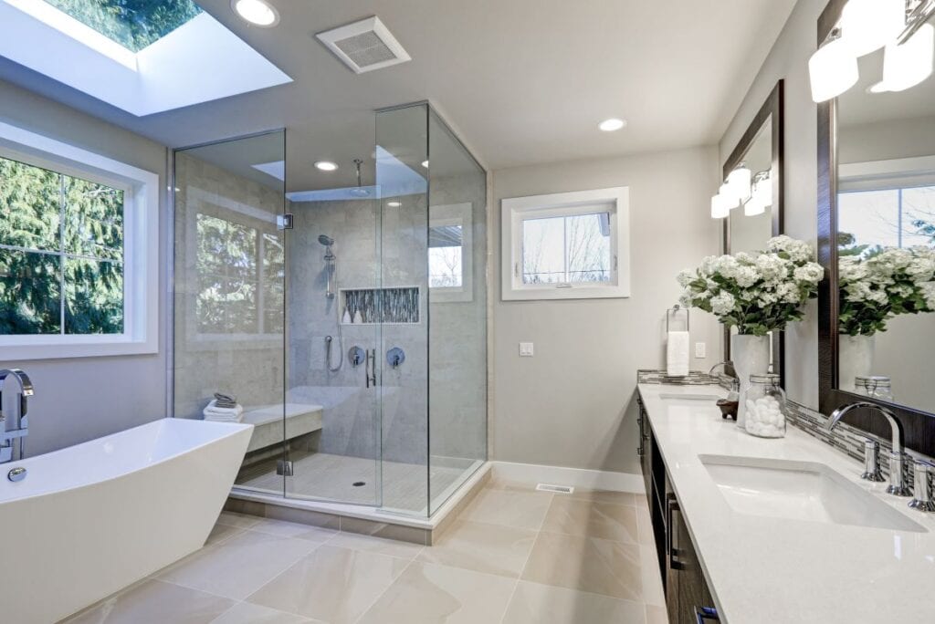 Transitional style bathroom with wood cabinets and glass shower