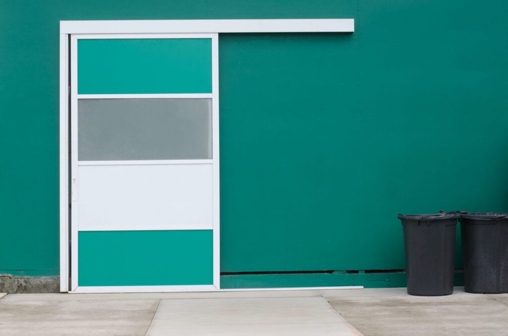 Deposit sliding door against pine green wall