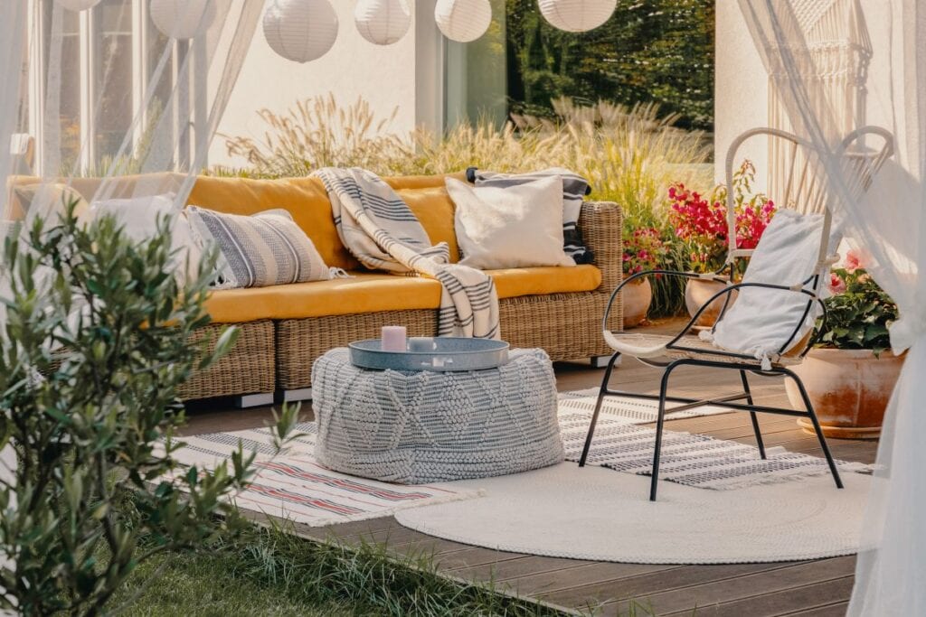 Modern boho chic patio, with string lantern lights and pouf