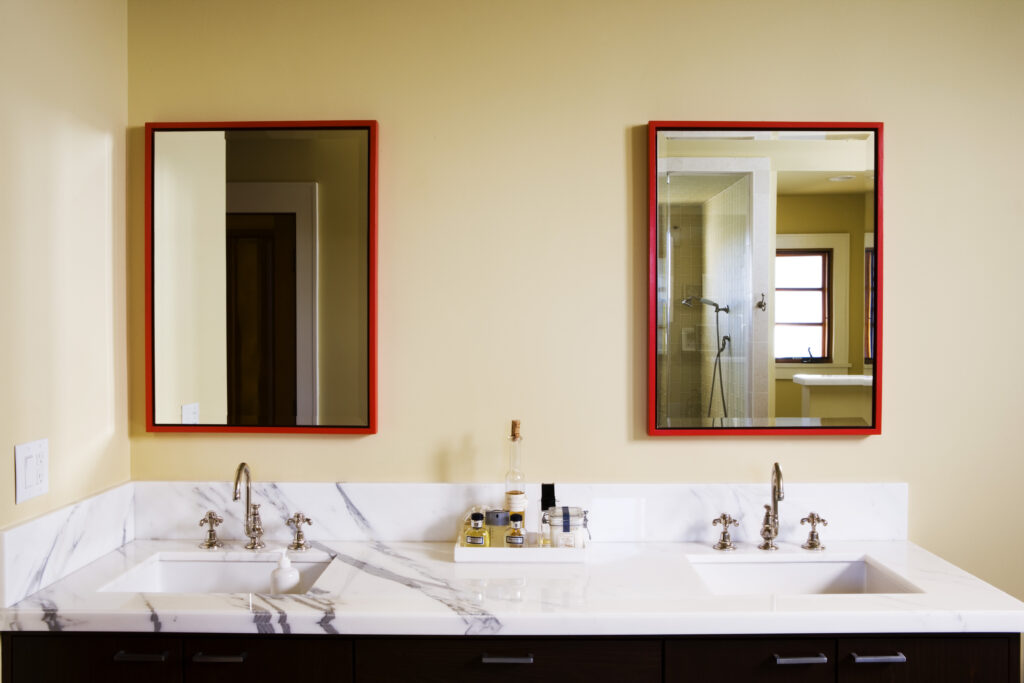 bathroom with red outlined mirrors 