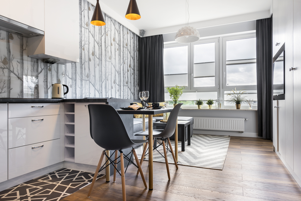 Modern small room with kitchen area and wooden floor