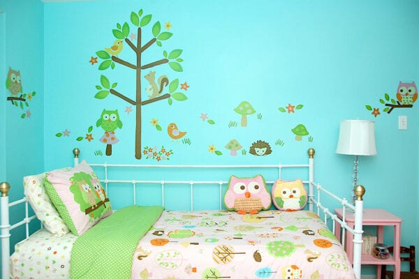 Girl bedroom painted bright turquoise and decorated with mushrooms and woodland.