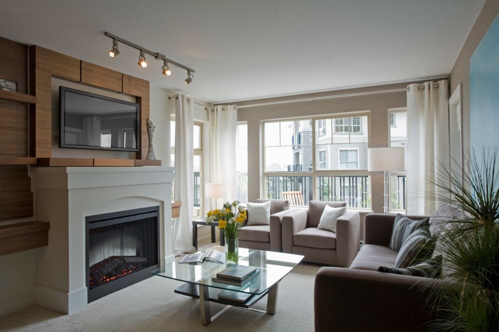 Modern living room with mounted tv above fireplace