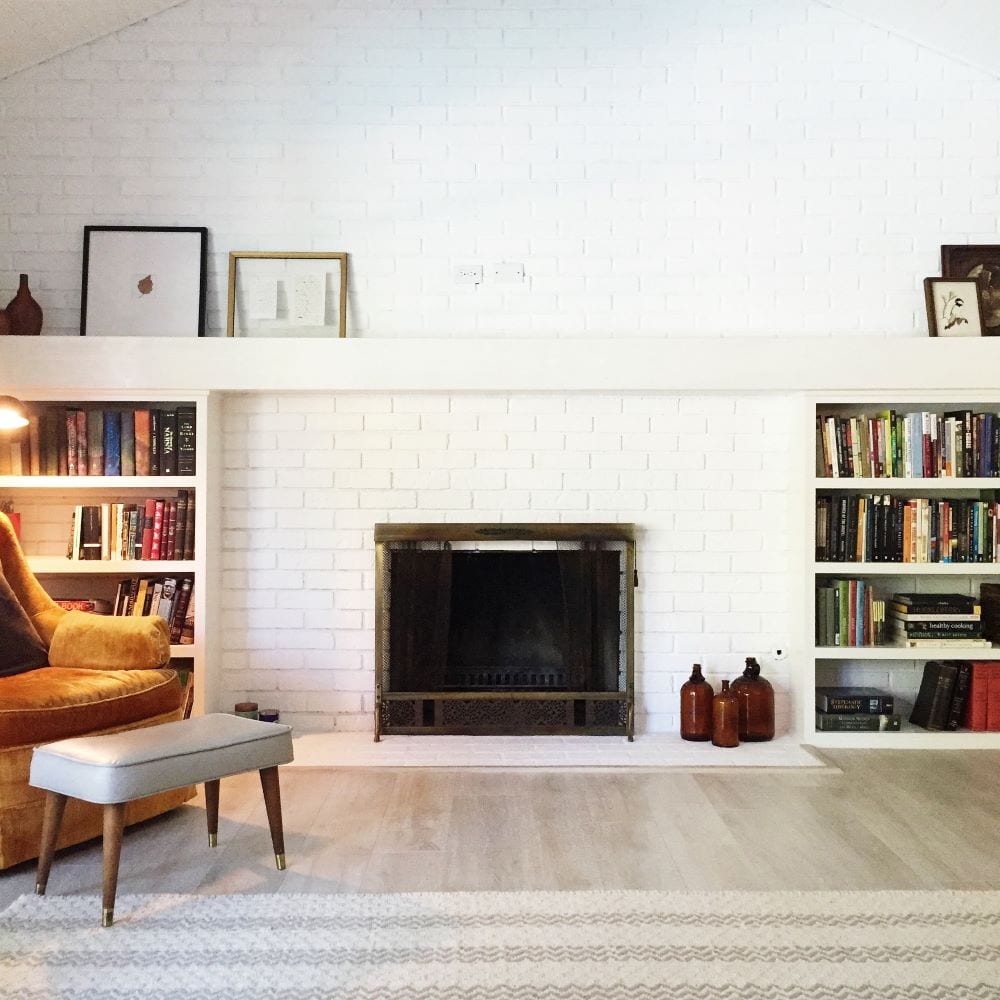 Fireplace with bookshelves and art for decor