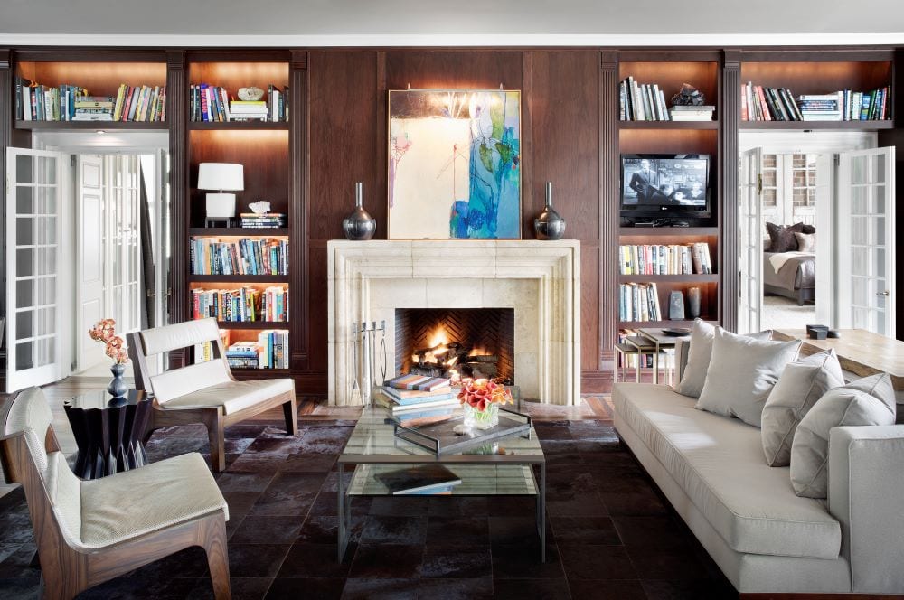 Living room with fireplace as focal point, bookshelves and art as decor