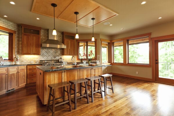 Open-plan kitchen with wooden cabinets and walnut floor